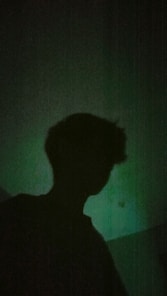 a silhouette of a person in a dark room