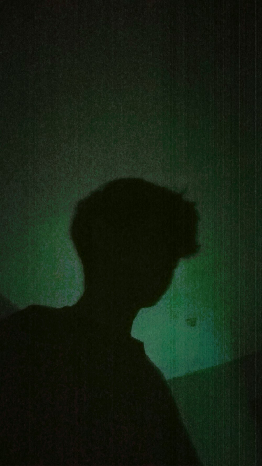 a silhouette of a person in a dark room