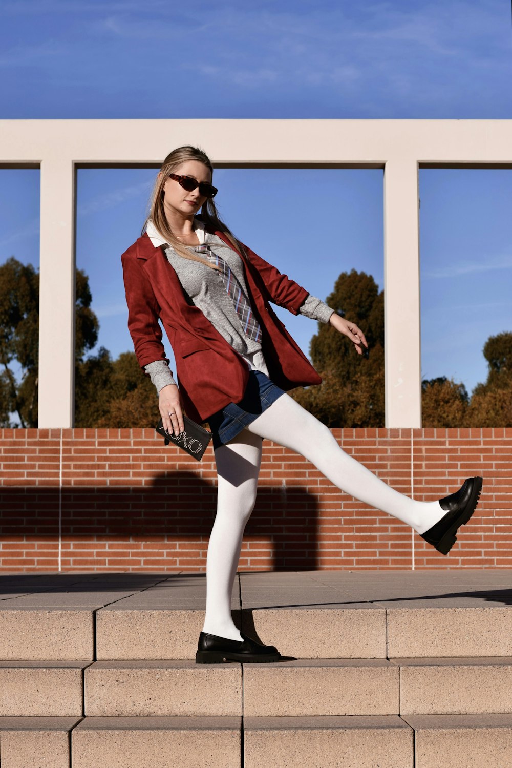 a woman in a red jacket and white tights