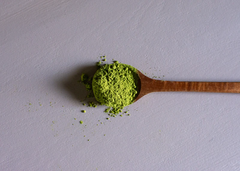 Natural herbal powder on a wooden spoon