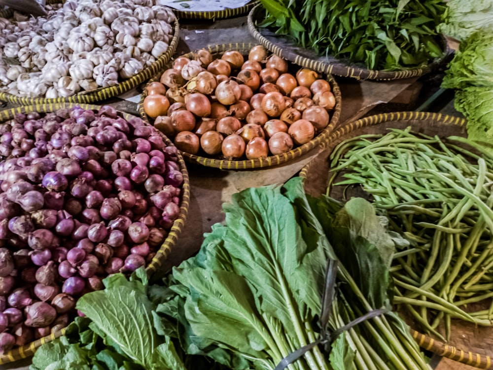 a table topped with baskets filled with lots of vegetables