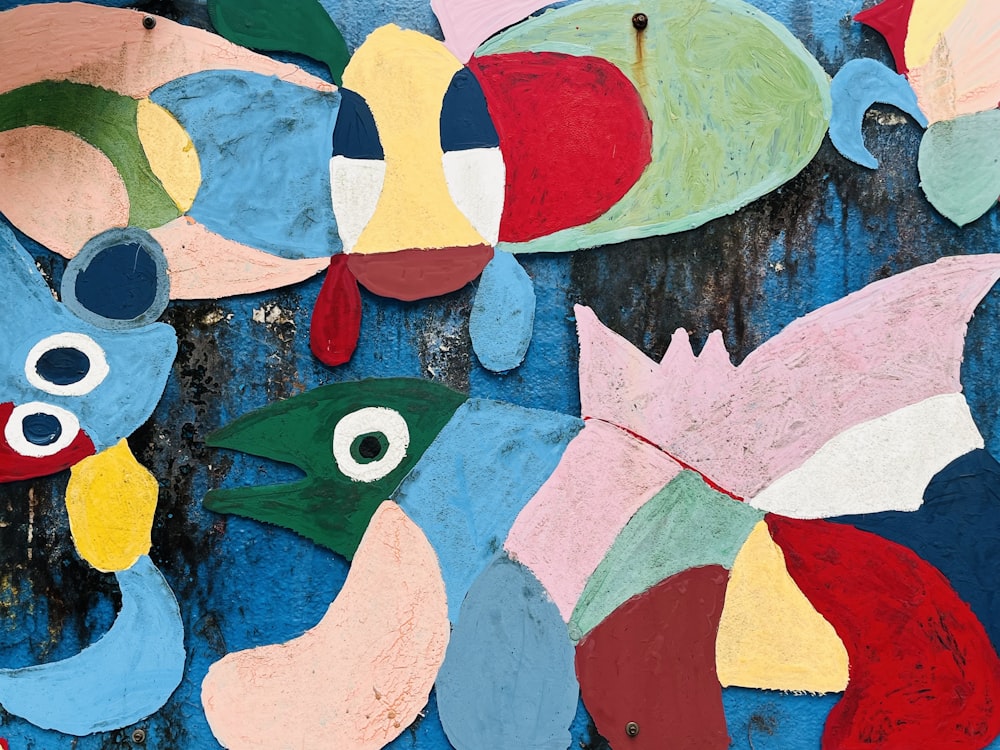a close up of a painting of fish on a wall