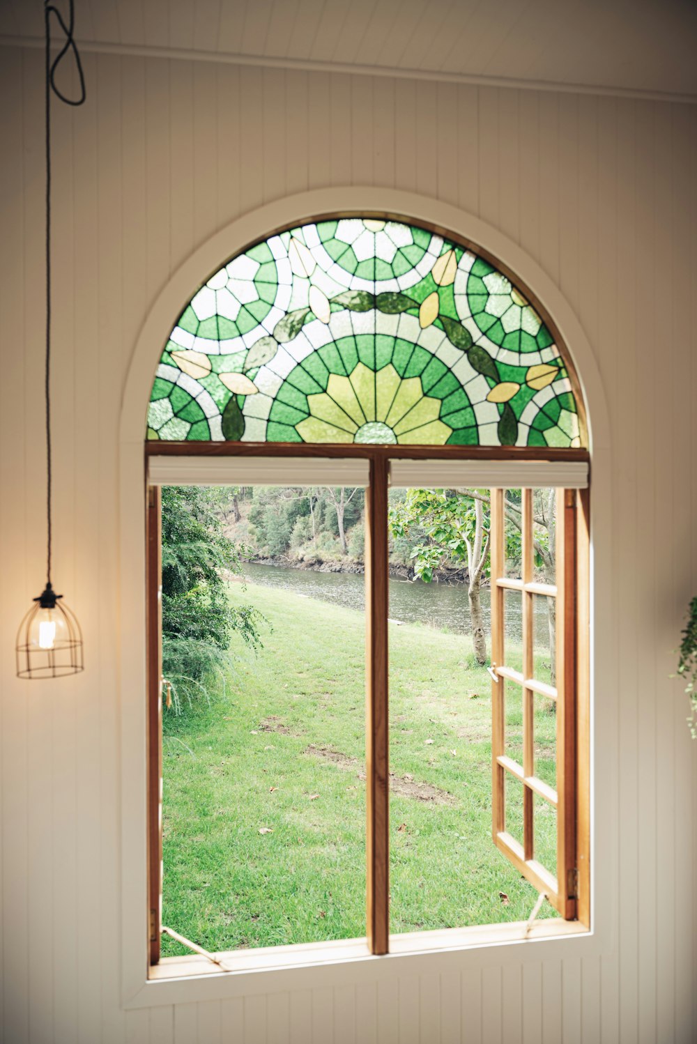 a window with a green and yellow stained glass design