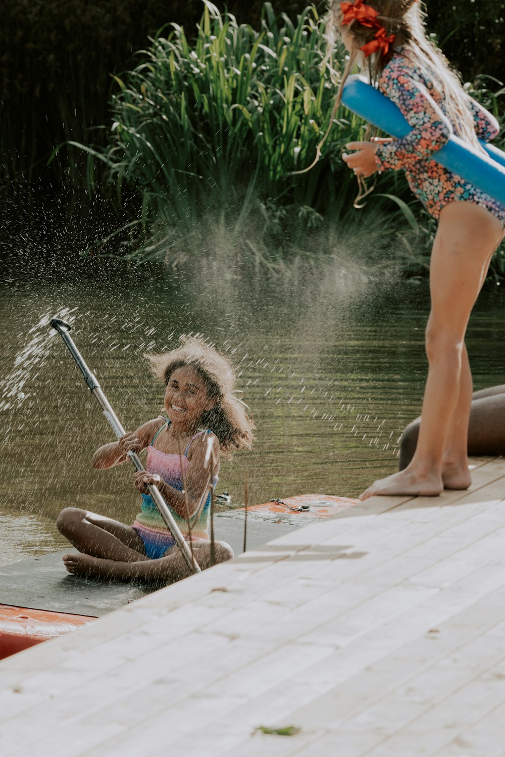a little girl is playing in the water