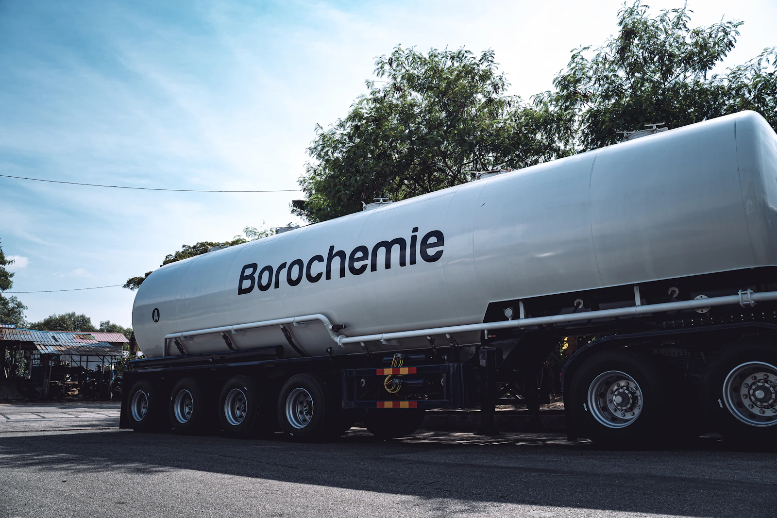 A large tanker truck stopped at the side of a road