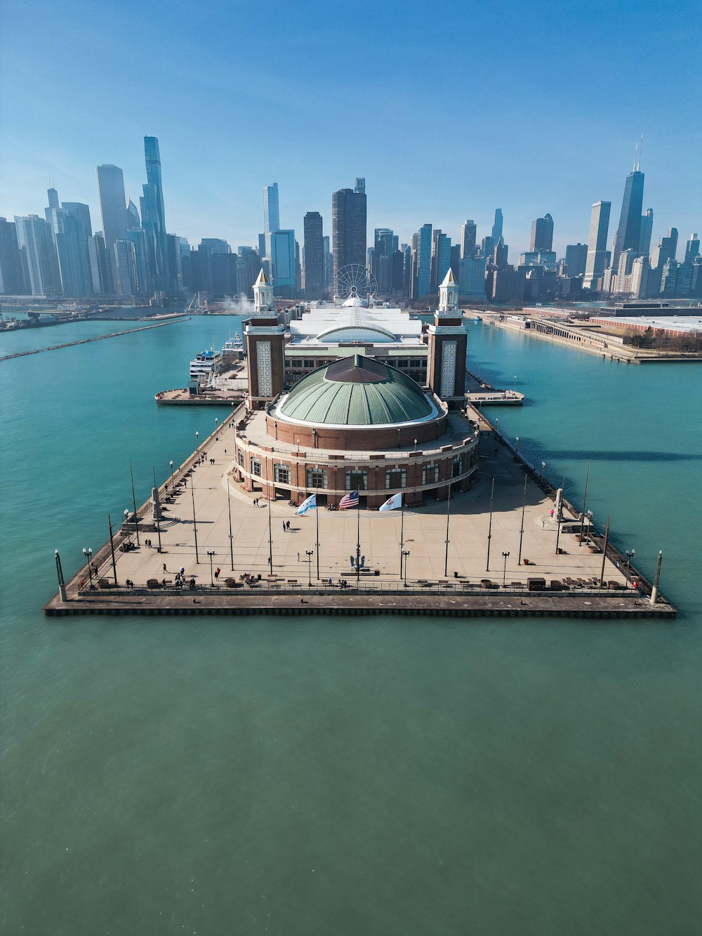 an aerial view of a large building in the middle of a body of water