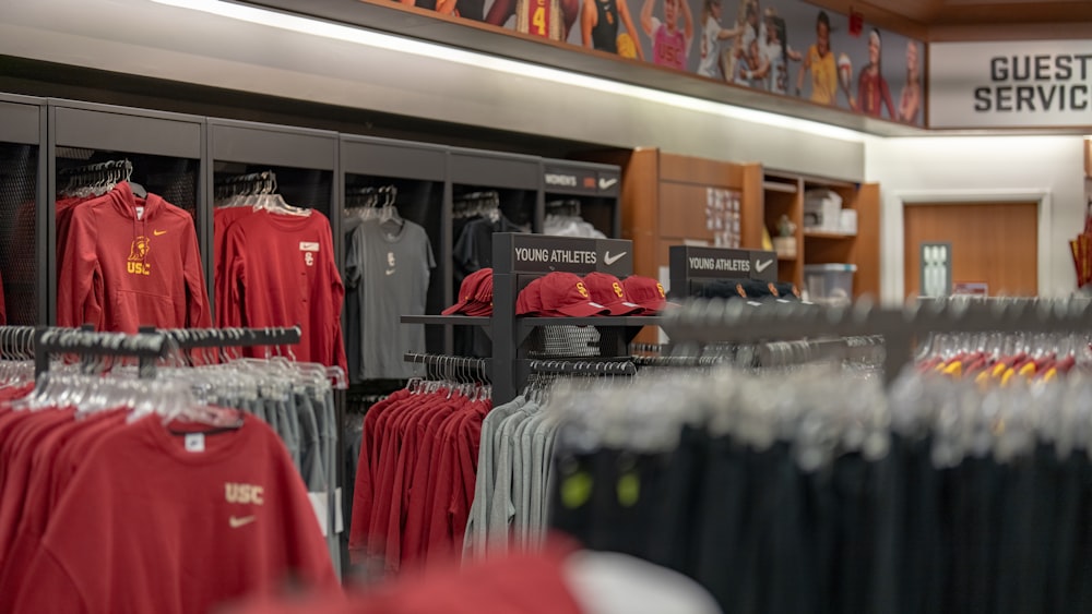 a store filled with lots of red and black shirts