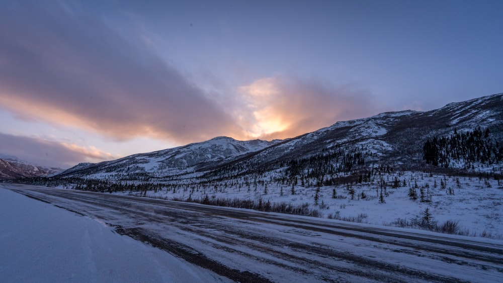 a road in the middle of a snowy mountain range