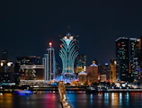 a city skyline at night with a bridge going across it