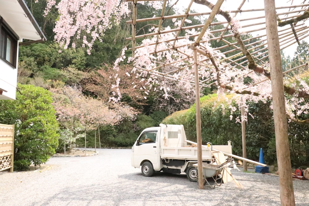 a white truck parked in front of a house