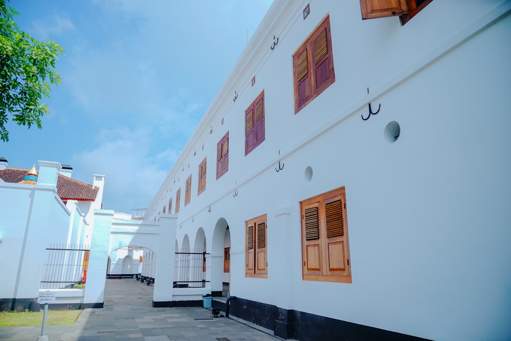 a white building with red shutters and windows