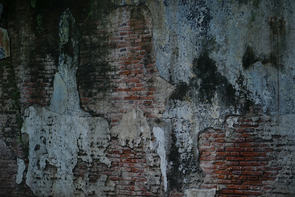 a red fire hydrant sitting in front of a brick wall