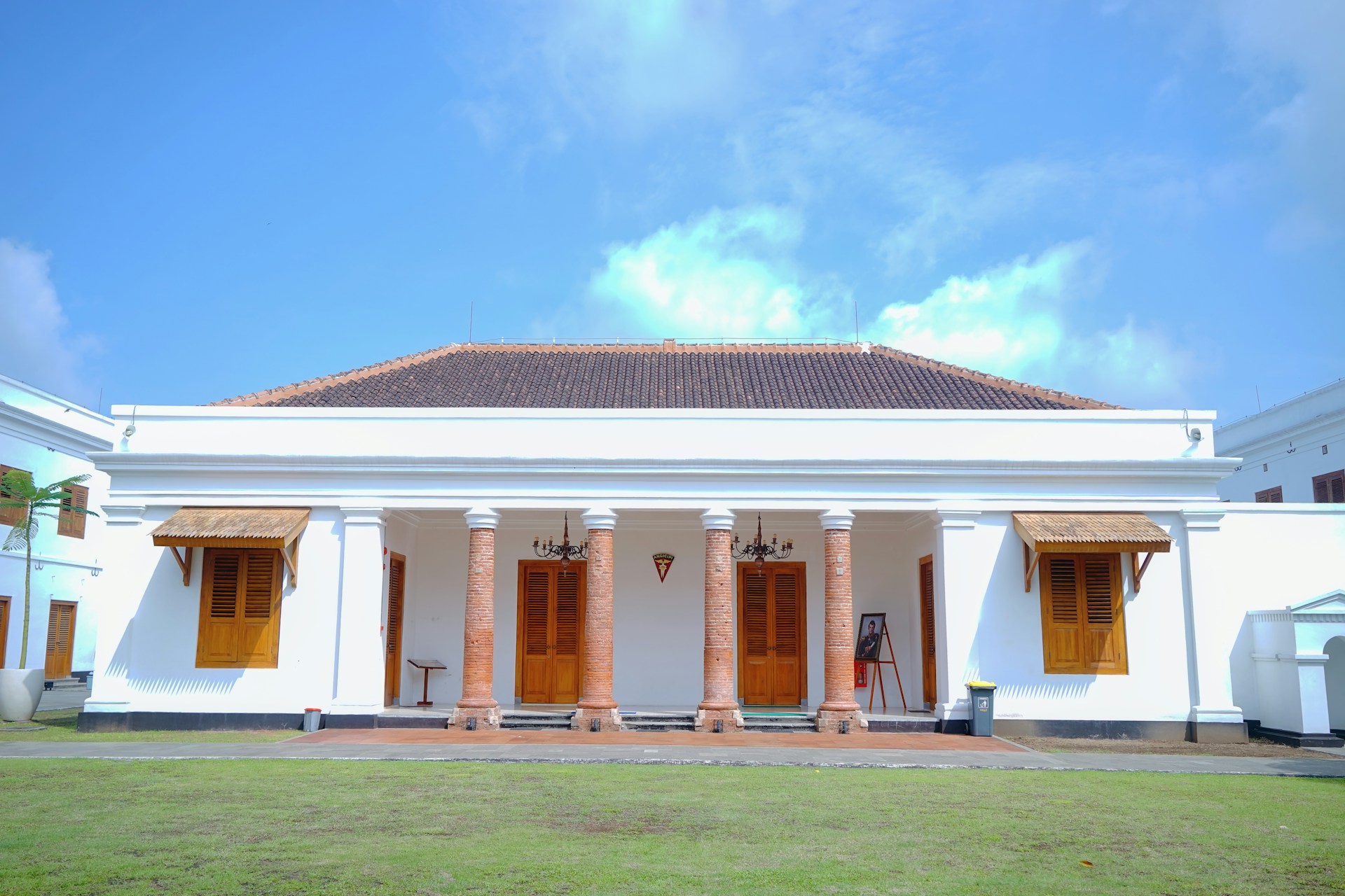 a large white building with columns and wooden doors