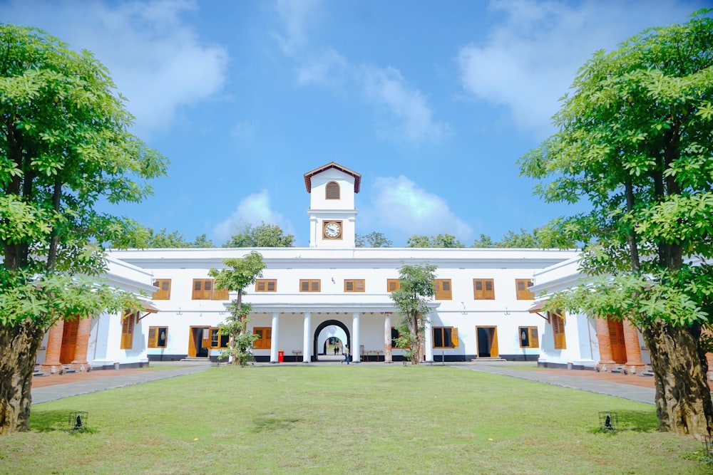 a large white building with a clock tower