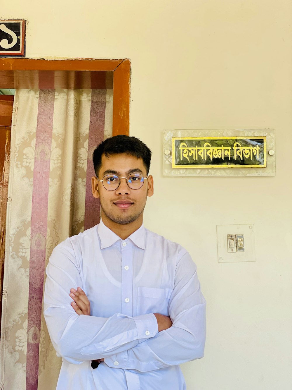 a man standing in front of a door with his arms crossed