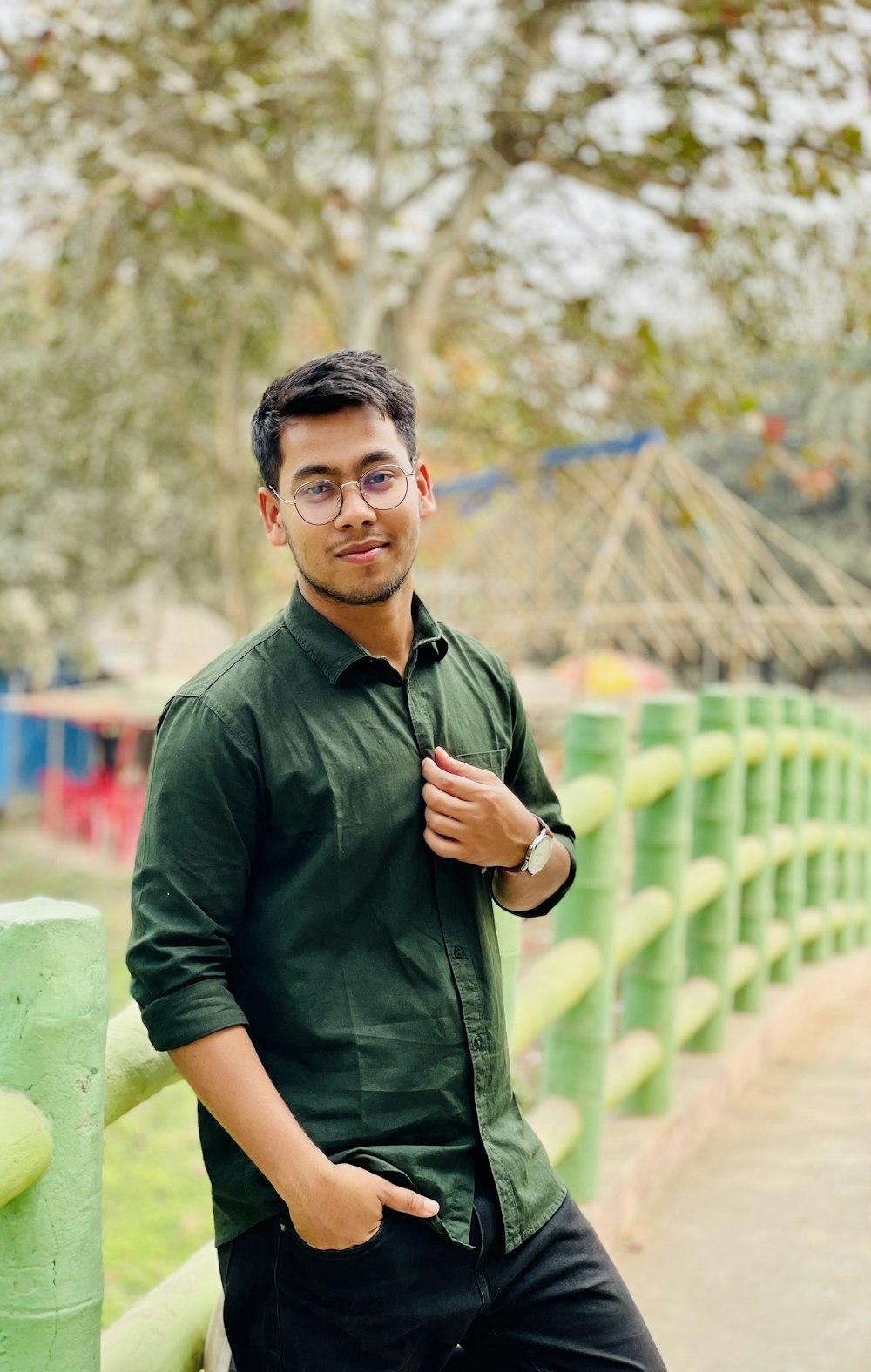 a man in a green shirt and black pants