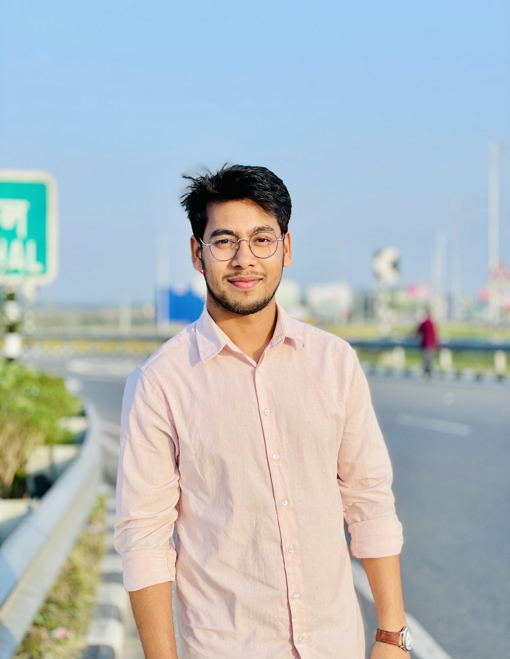 a man standing on the side of a road