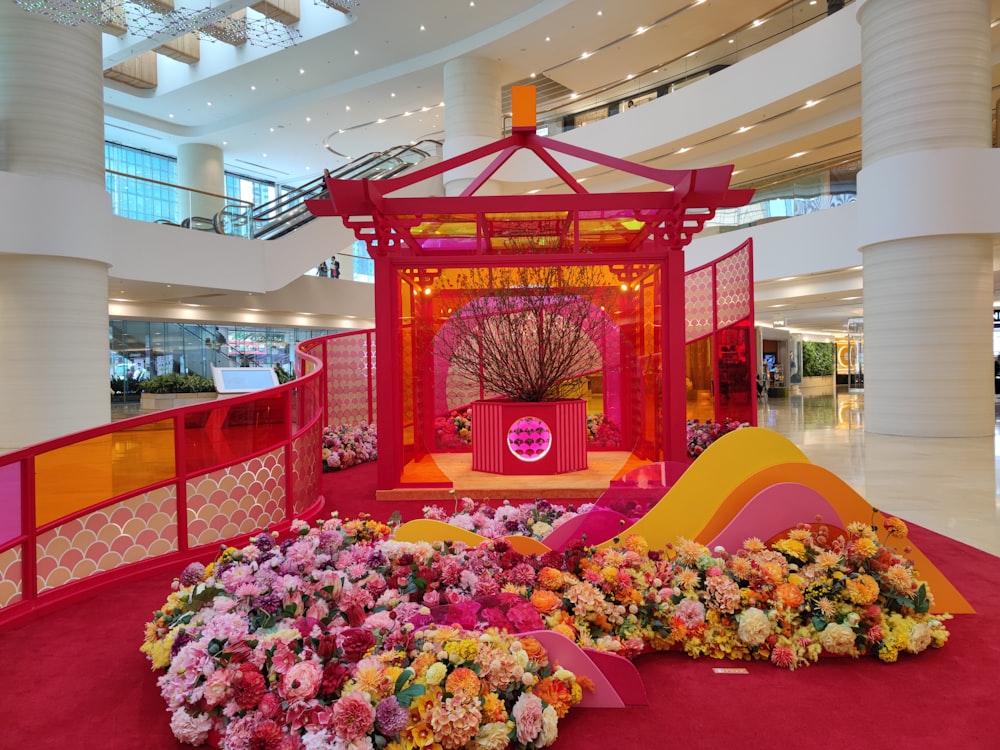 a display in a mall with flowers on the floor