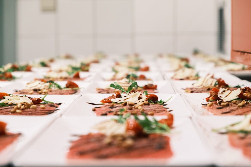 a table topped with lots of plates of food