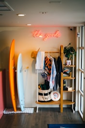 a surfboard and a surfboard rack in a room