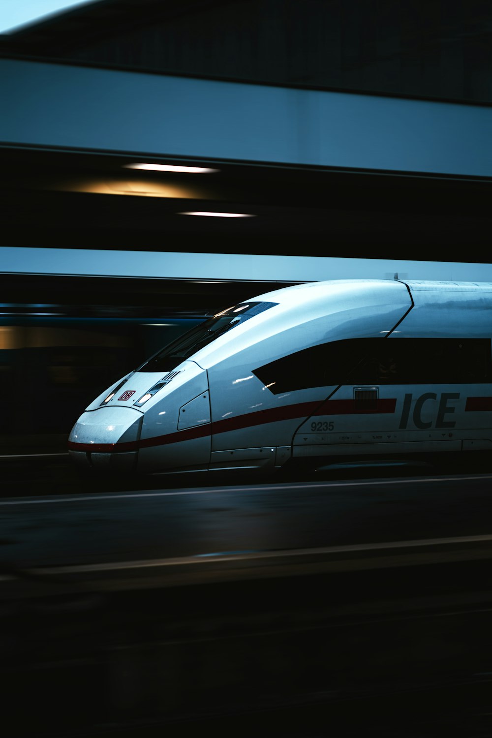 a high speed train traveling through a train station