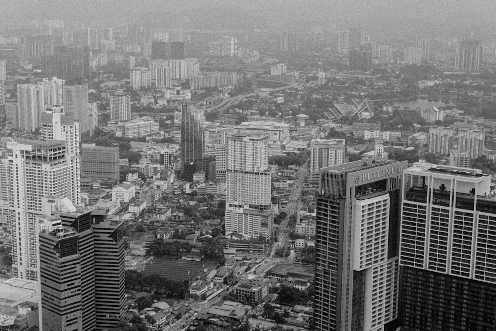 a black and white photo of a city with tall buildings