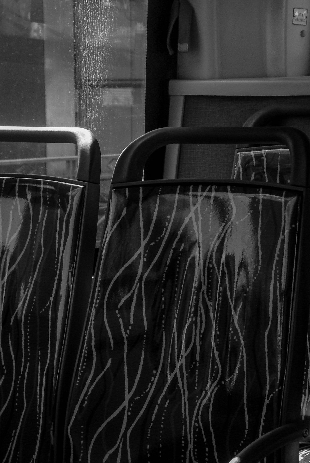 a black and white photo of a bus seat