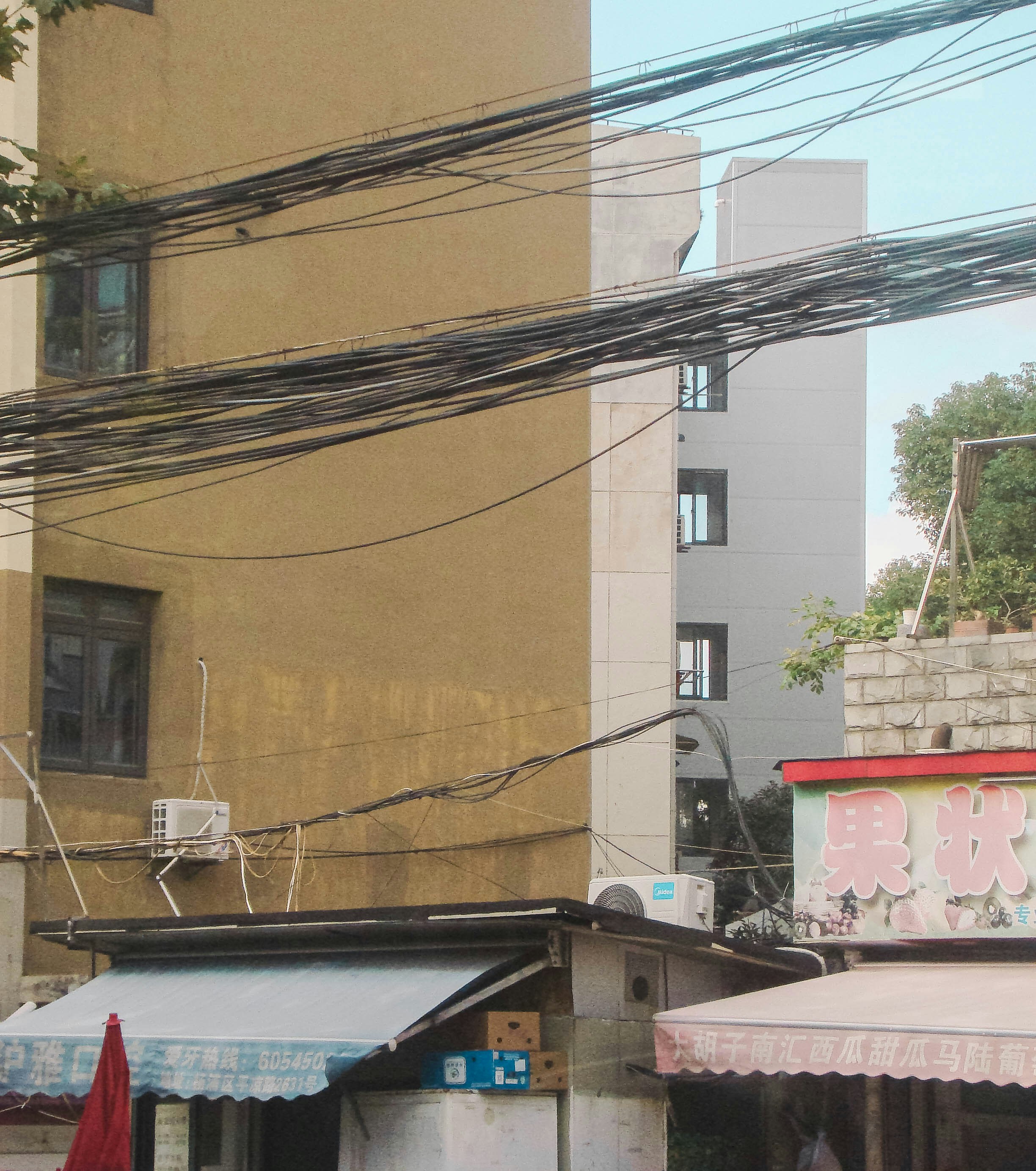 A couple of buildings that have power lines above them photo – Free ...