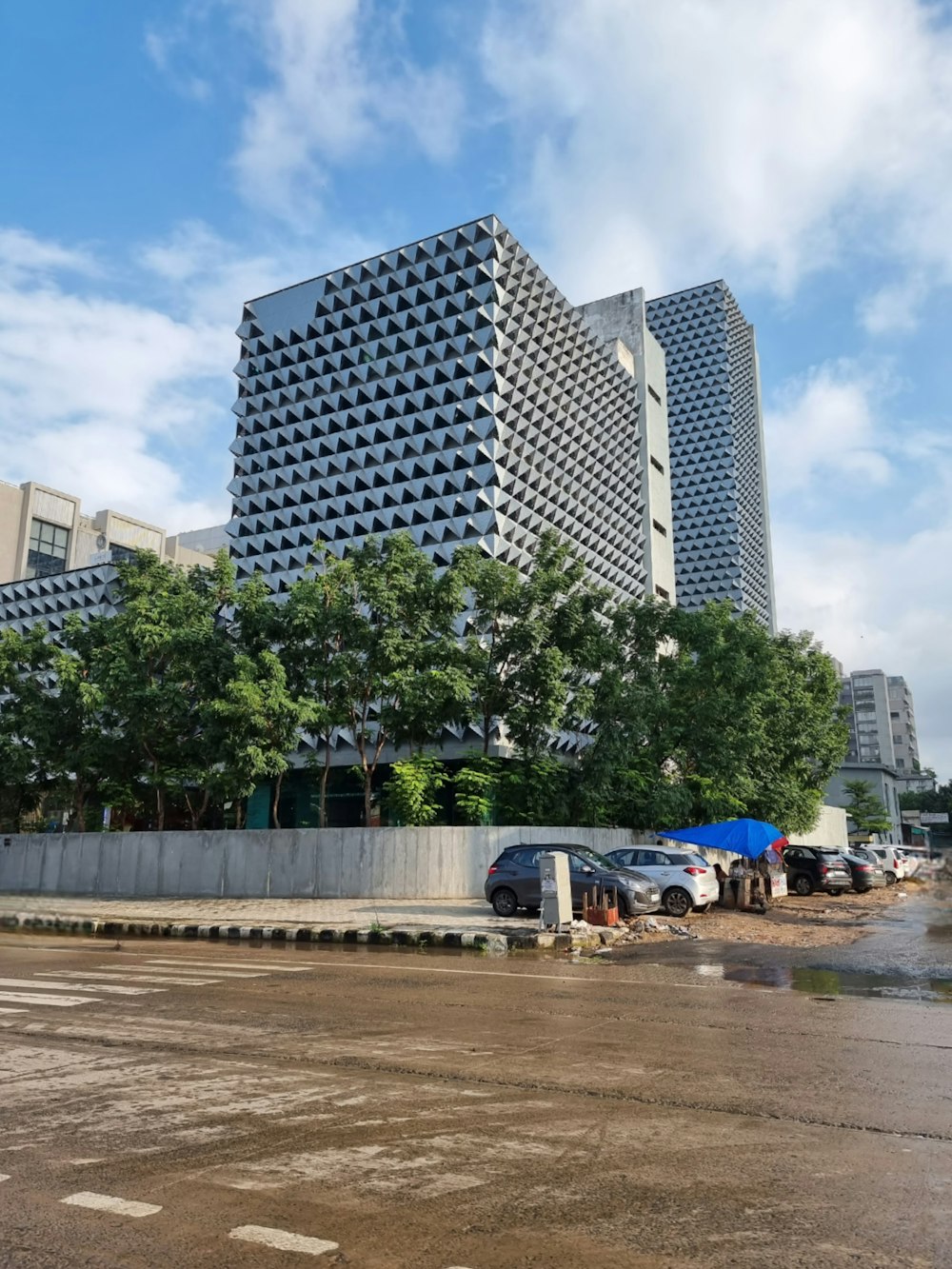 a very tall building sitting next to a parking lot