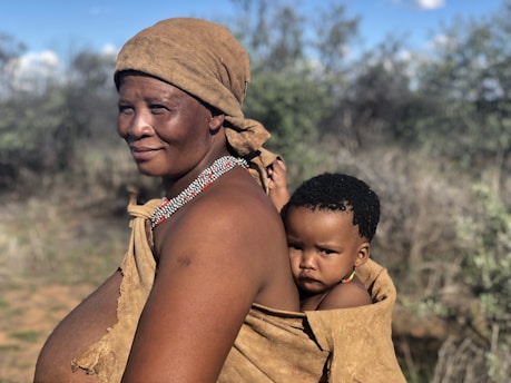 a woman carrying a child on her back