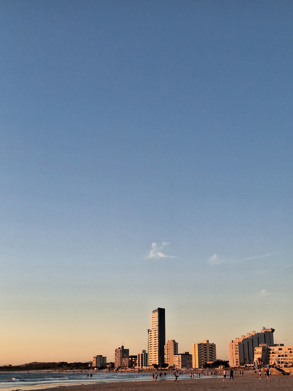 a kite flying in the air over a beach