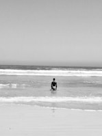 a man sitting on a surfboard in the ocean