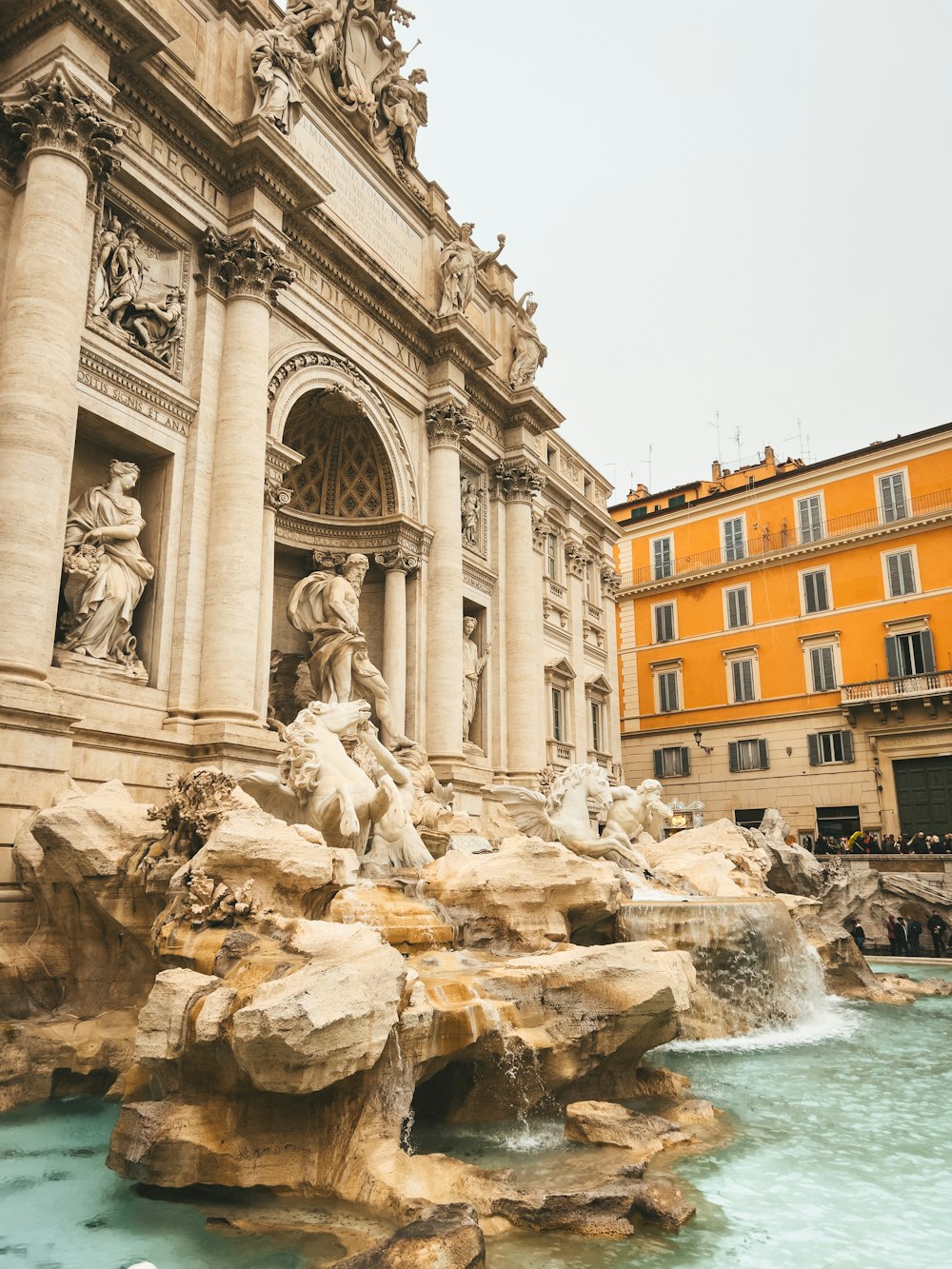 a large building with a fountain in front of it