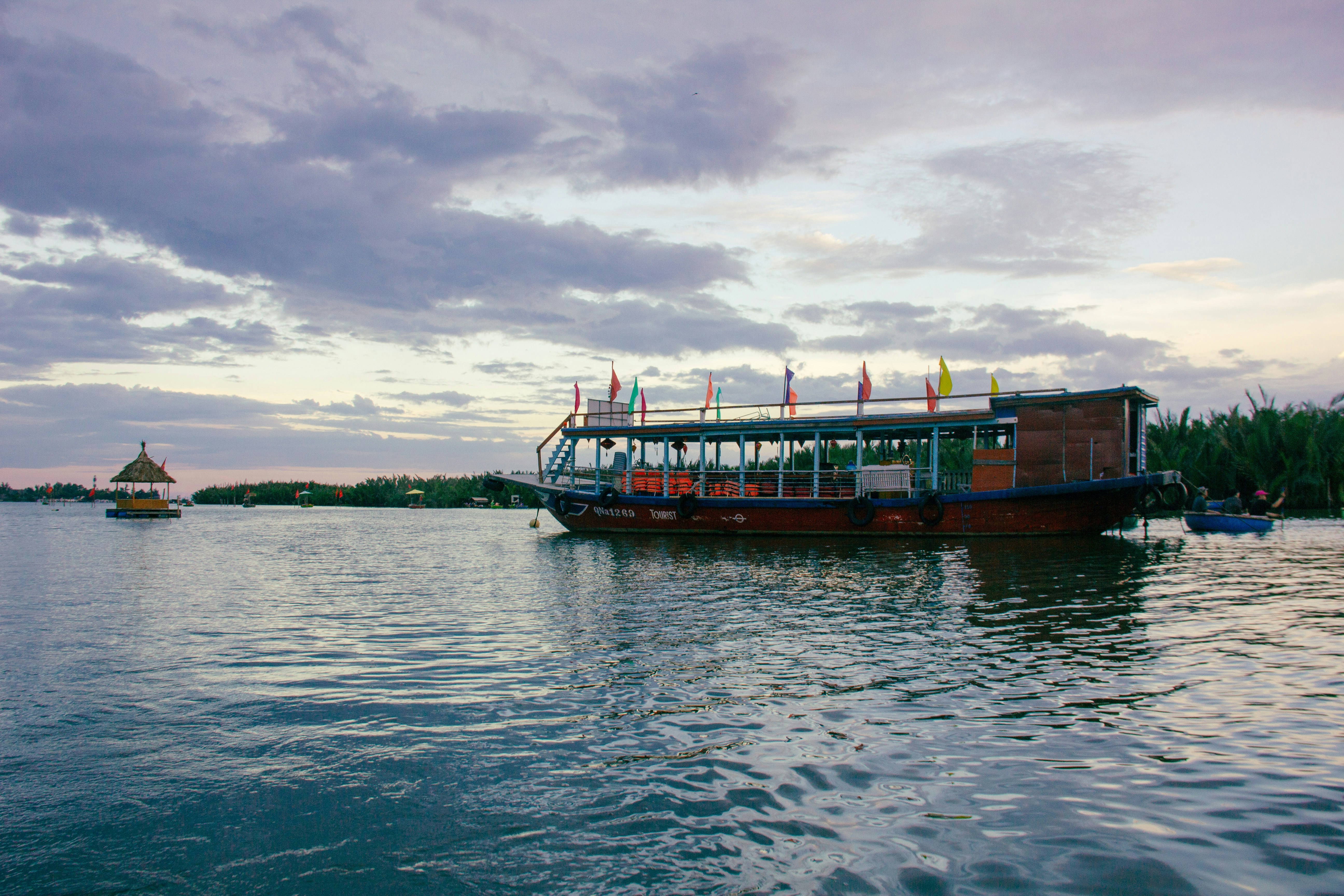 a boat is on the water with a sky background