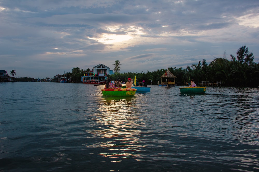 a group of small boats floating on top of a lake