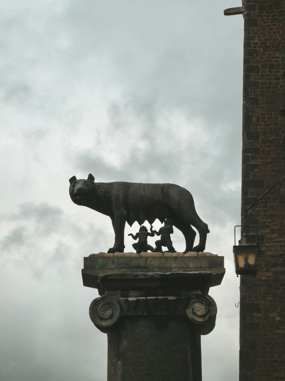 a statue of a bear on top of a pillar