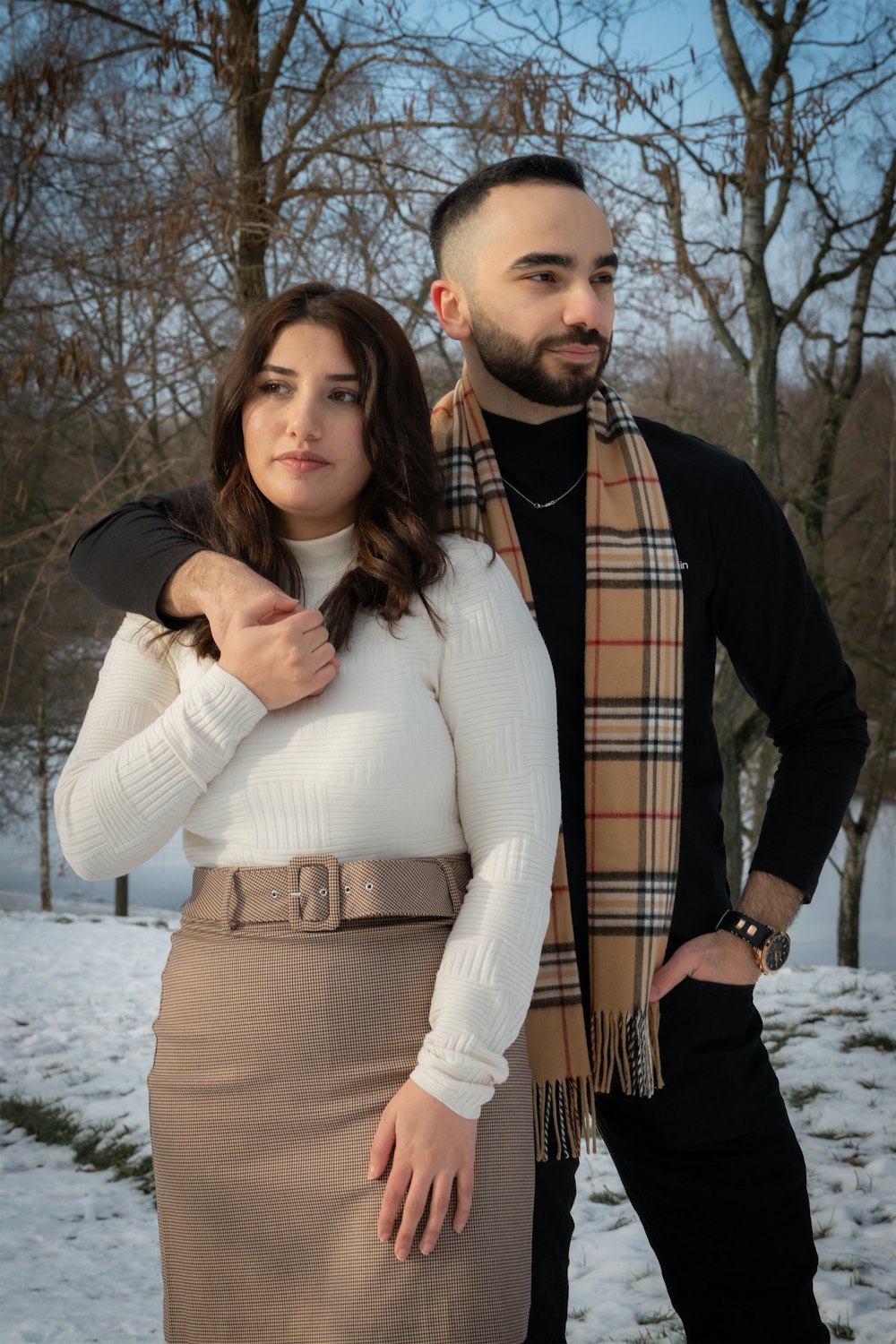 a man and a woman standing in the snow