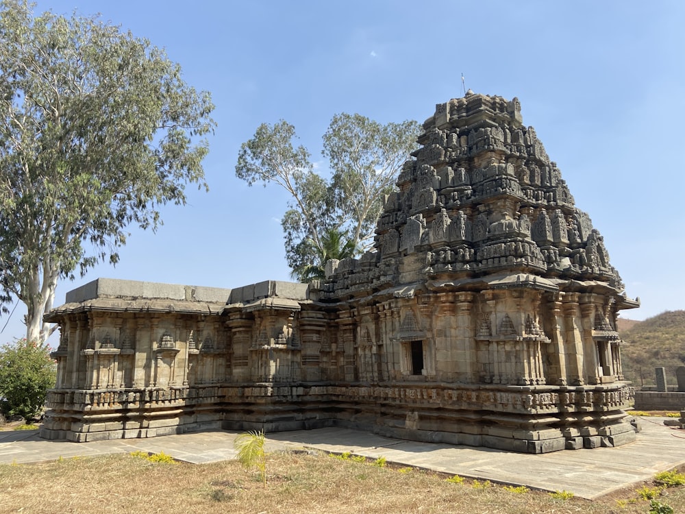 a large stone structure with a tree in the background