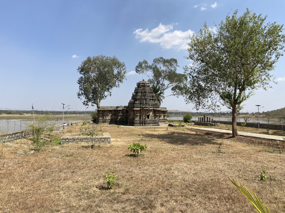 a small temple in the middle of a field