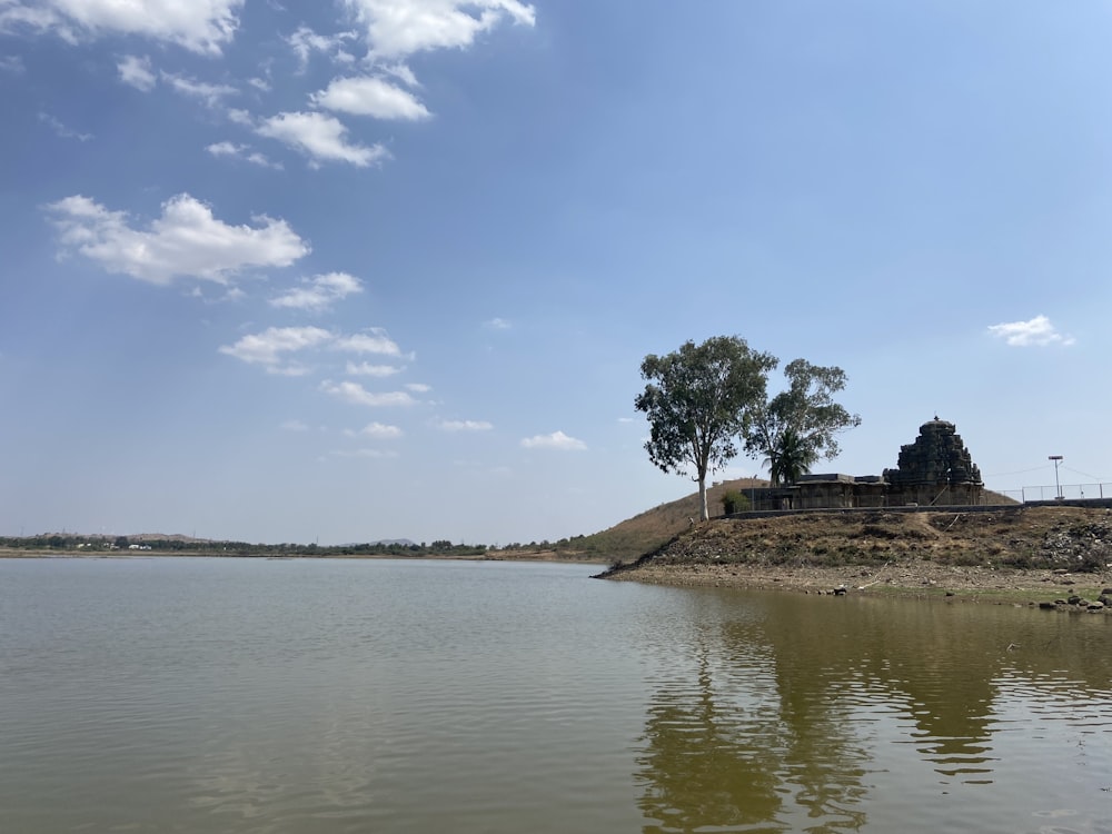 a body of water with a hill in the background