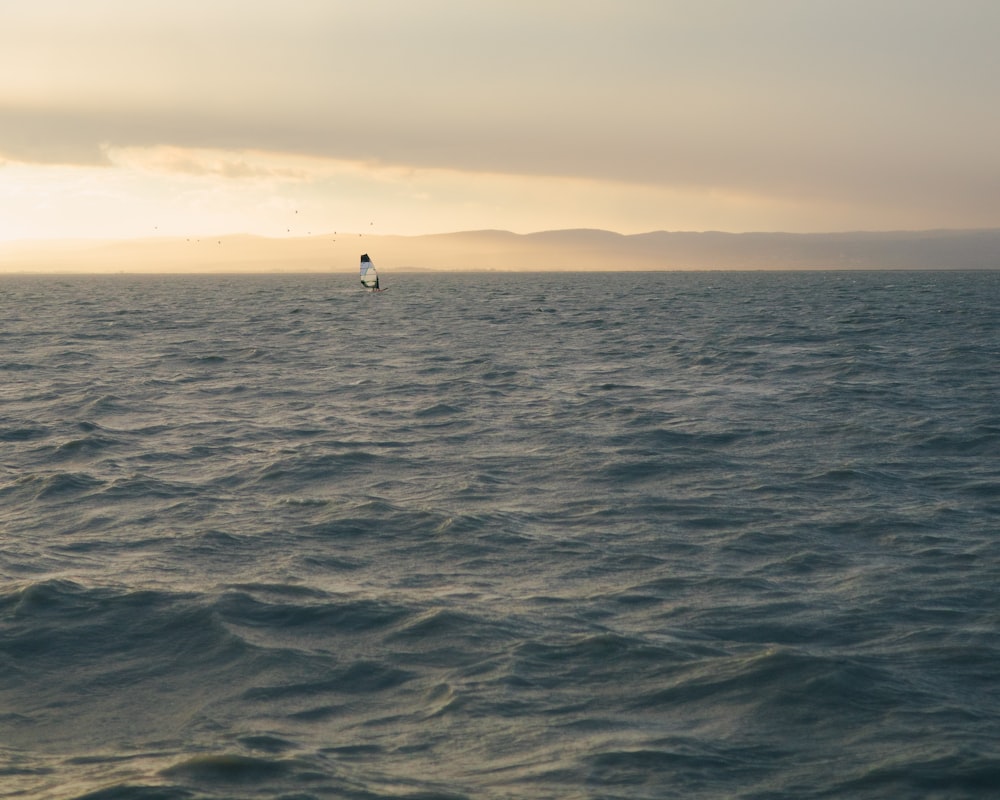 a person on a surfboard in the middle of the ocean