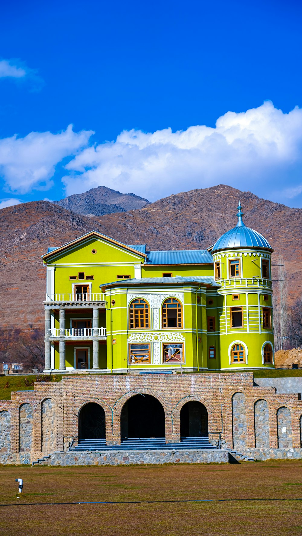 a large yellow building with a blue roof