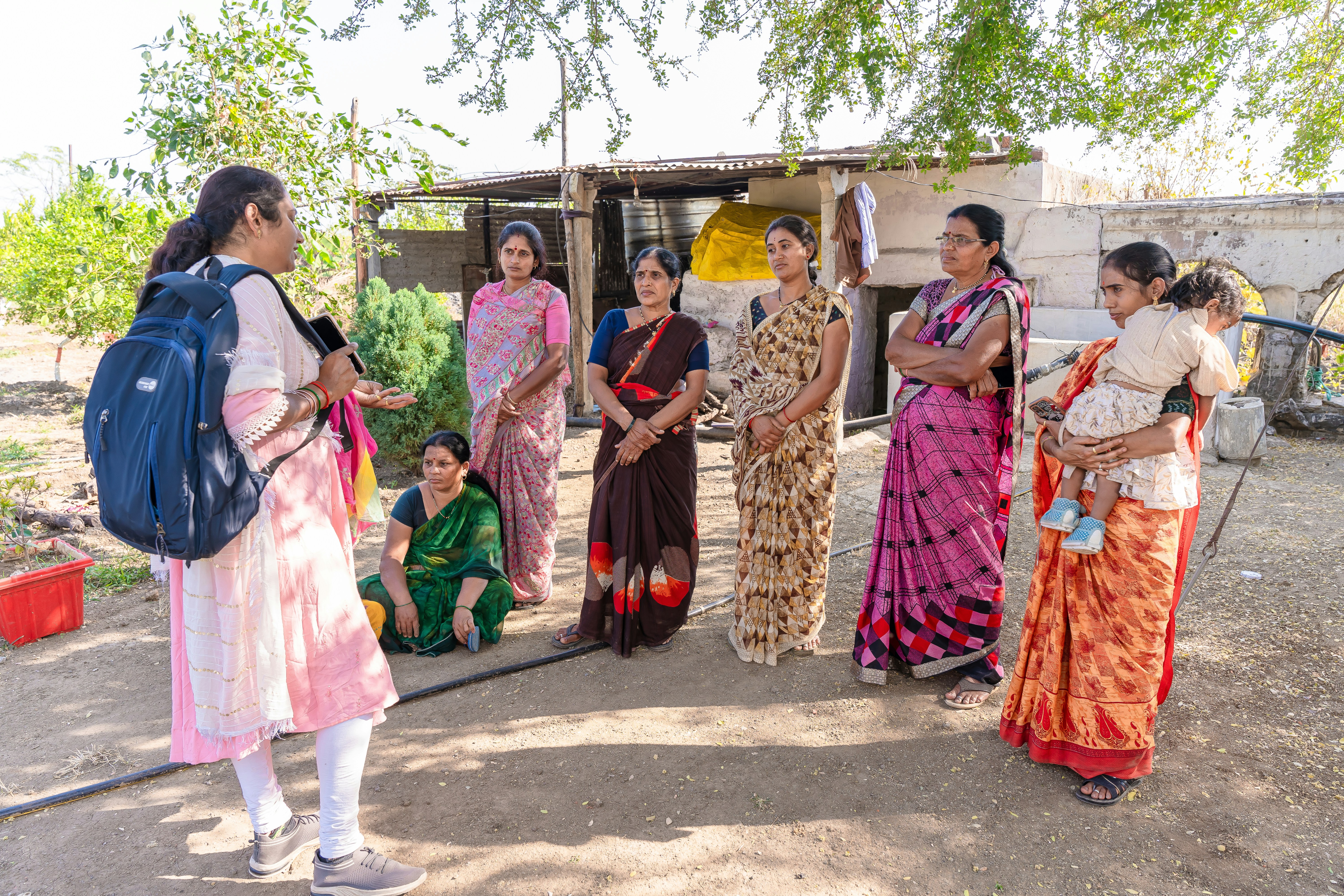 A high-level meeting room with ministers and officials seated around a large table, listening intently to a speaker (representing PM Modi, though he won't be visible), with maps and charts on the screen.