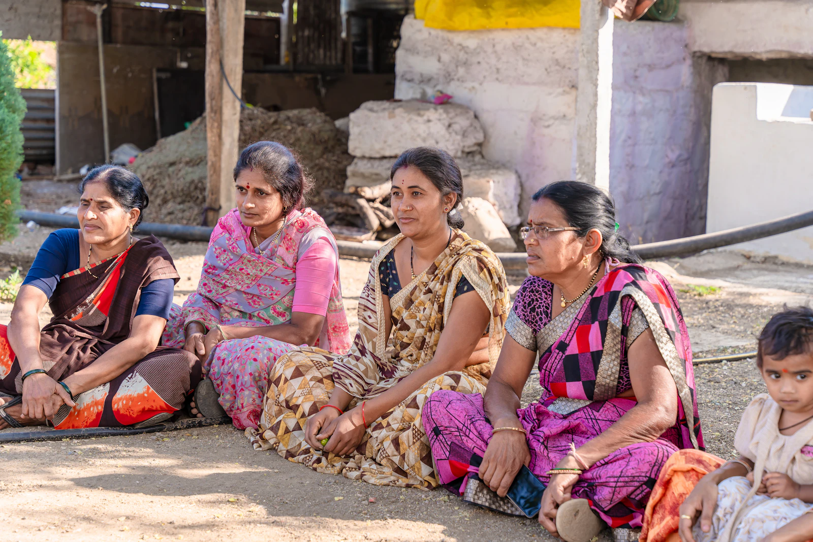 A group of women seated together in a savings group meeting
