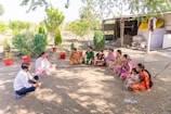 a group of women sitting on the ground in a circle