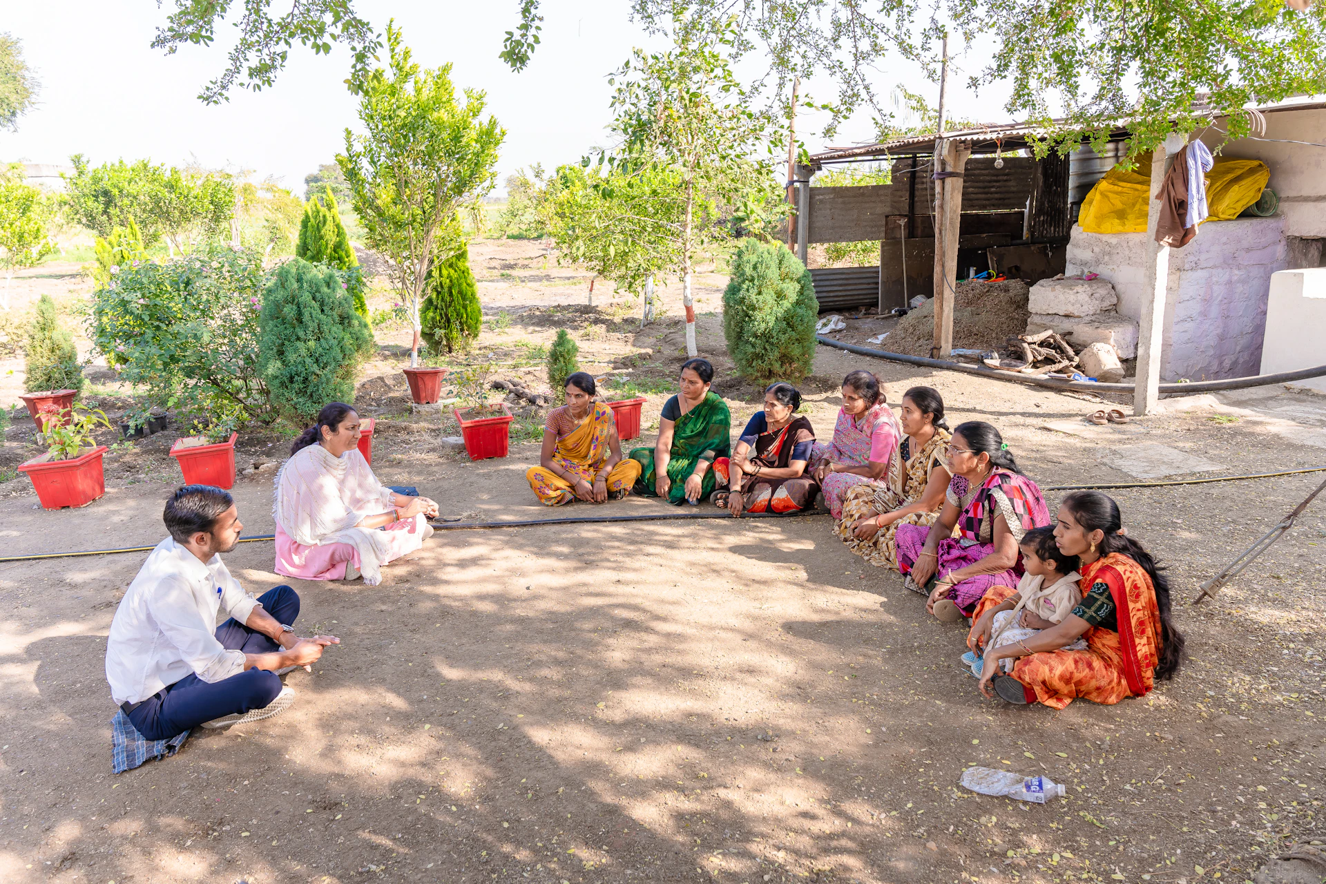 a group of women sitting on the ground in a circle