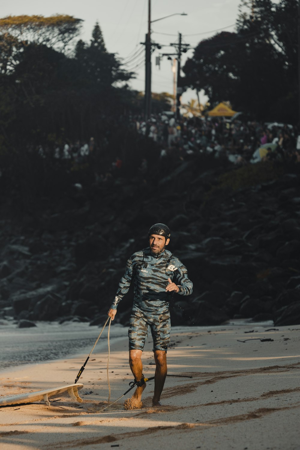 a man walking a dog on the beach