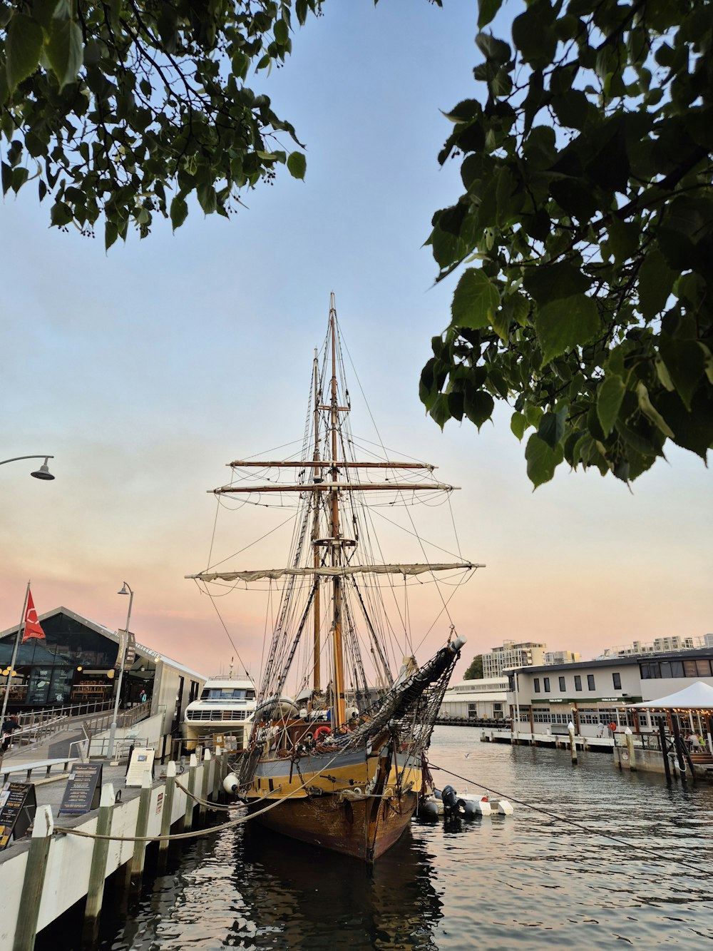 a large boat is docked at a pier