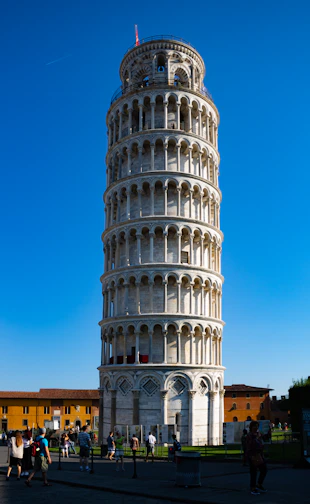 a very tall tower with people walking around it