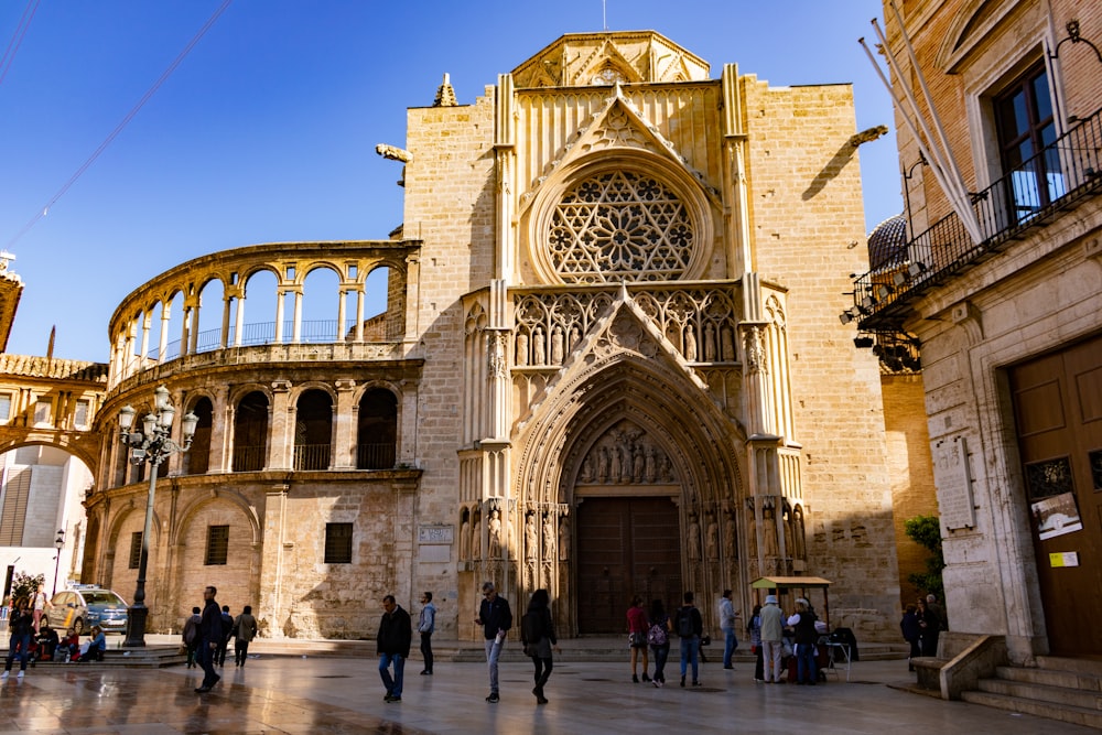 a group of people walking in front of a church